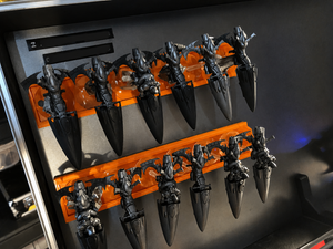 Twelve jetbike miniatures on a flight stand tray inside a magnetic storage case