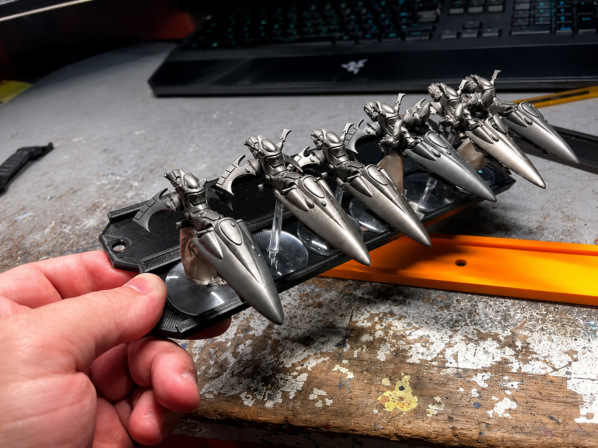 Flight stand tray tilted while holding jetbike miniatures without dropping them
