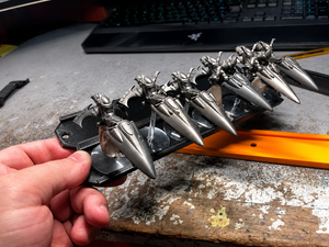 Flight stand tray tilted while holding jetbike miniatures without dropping them