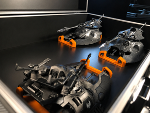 Grav-tank miniatures held by orange Magnetic Anchors inside a transport case