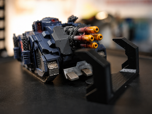 3D printed black magnetic clip holding a tank miniature
