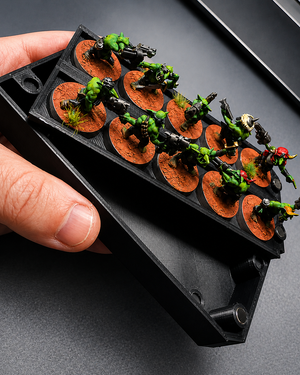 Magnetic tray and weapon options box stacked together with Ork Boyz, held in hand